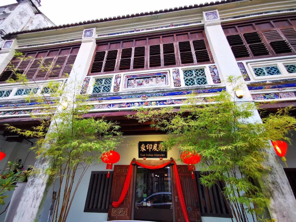 a building with a red door in front of it at East Indies Mansion in George Town