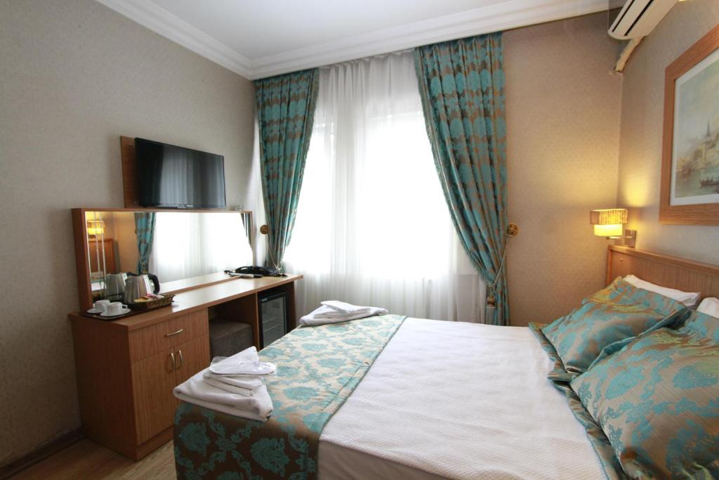 A bed or beds in a room at Agora Boutique Hotel & Bistro