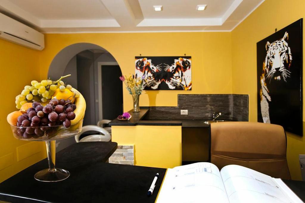 a kitchen with a bowl of fruit on a table at Locanda Paradiso in Genova