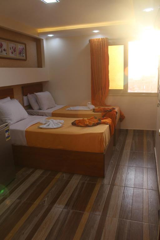 Postel nebo postele na pokoji v ubytování Osiris Hotel Cairo
