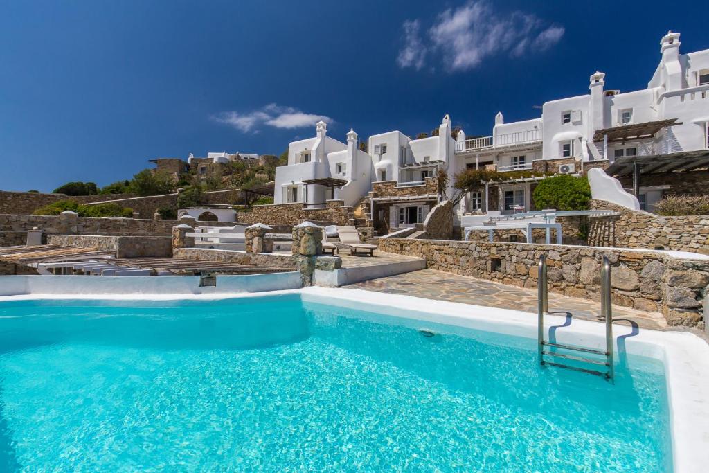 a swimming pool in front of a villa at Seablue Villas in Houlakia