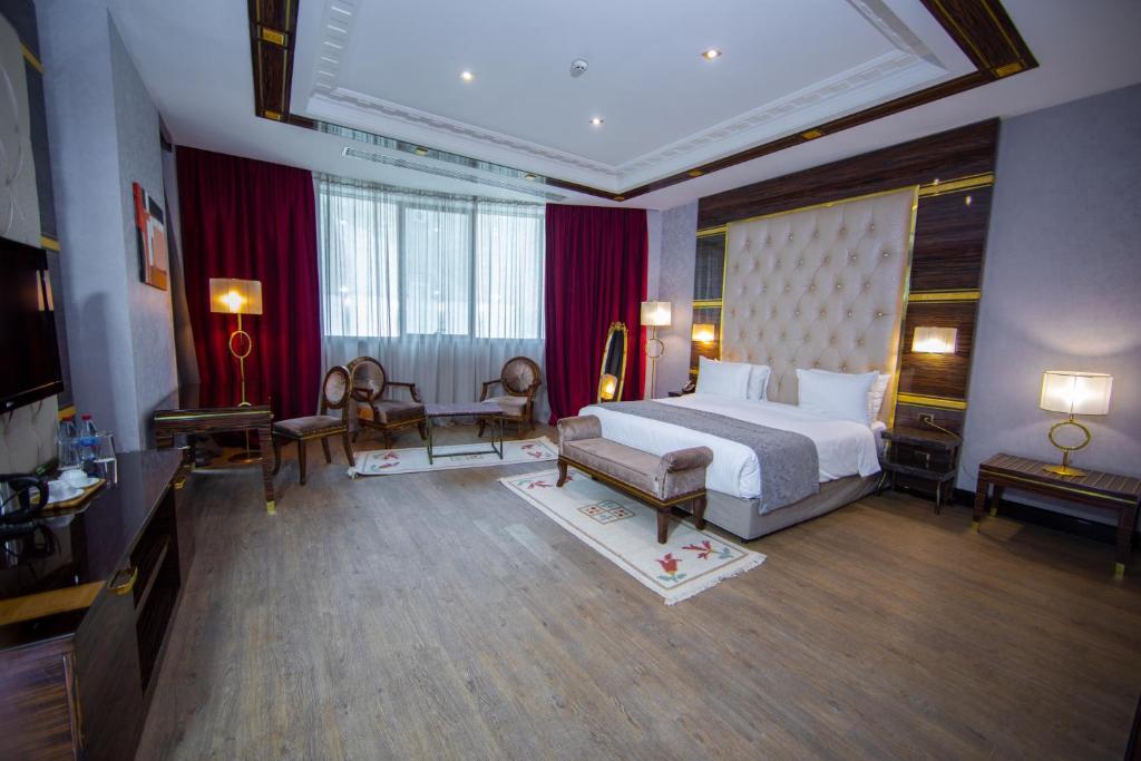a large hotel room with a bed and a television at Sapphire Hotel in Baku