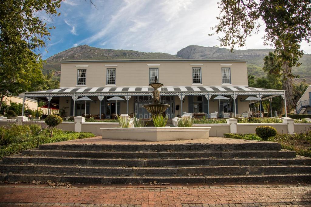 a building with a fountain in front of it at Pontac Manor Hotel & Restaurant in Paarl