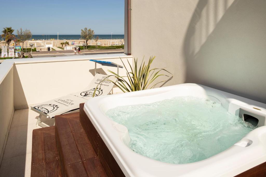 a bath tub sitting on top of a balcony at Hotel Ambassador in Rimini