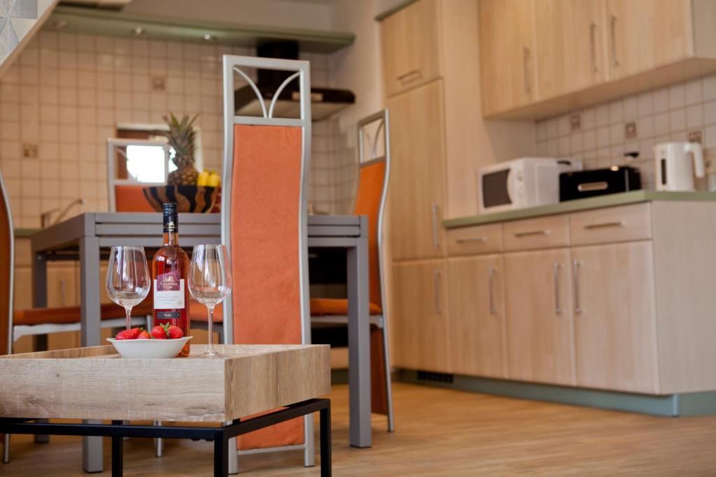 a kitchen with a table with wine bottles and glasses at Haus Weinbergblick in Haigerloch