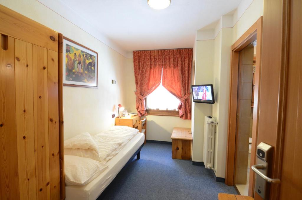 Postel nebo postele na pokoji v ubytování Albergo Alpenrose