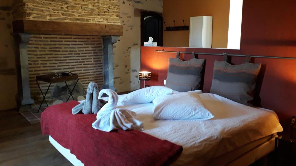 a bedroom with a large bed with swans on it at Le Buala Maison d'Hôtes in Antist