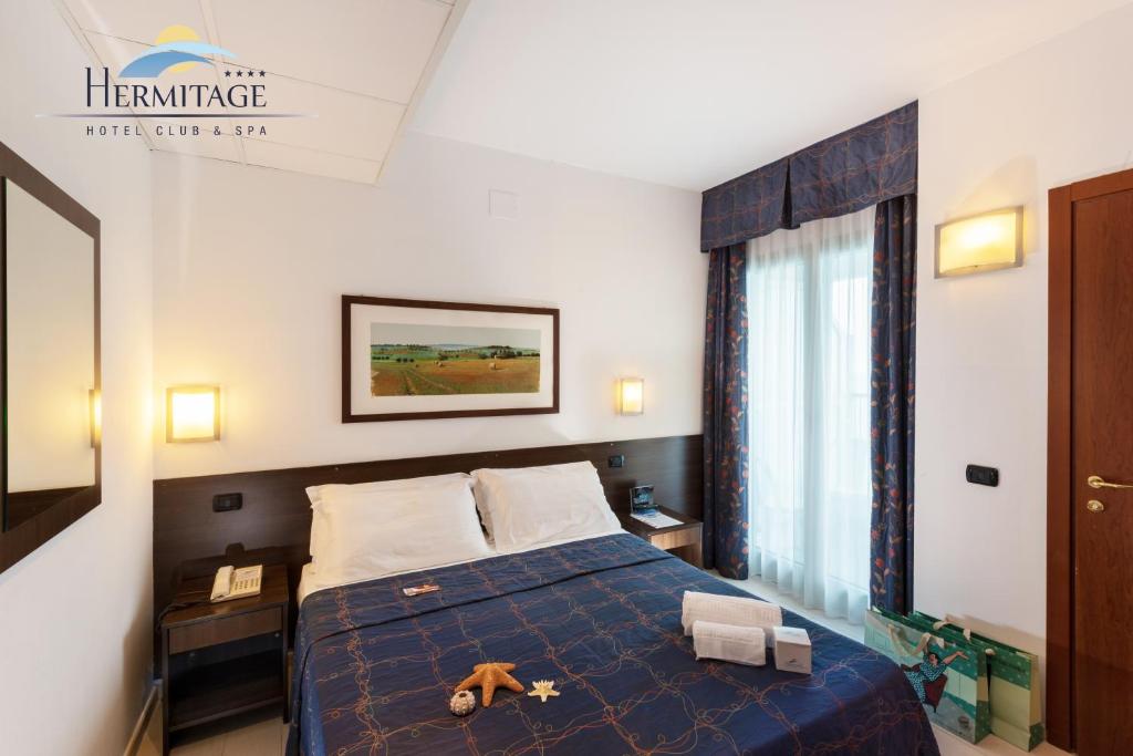A bed or beds in a room at Hermitage Hotel