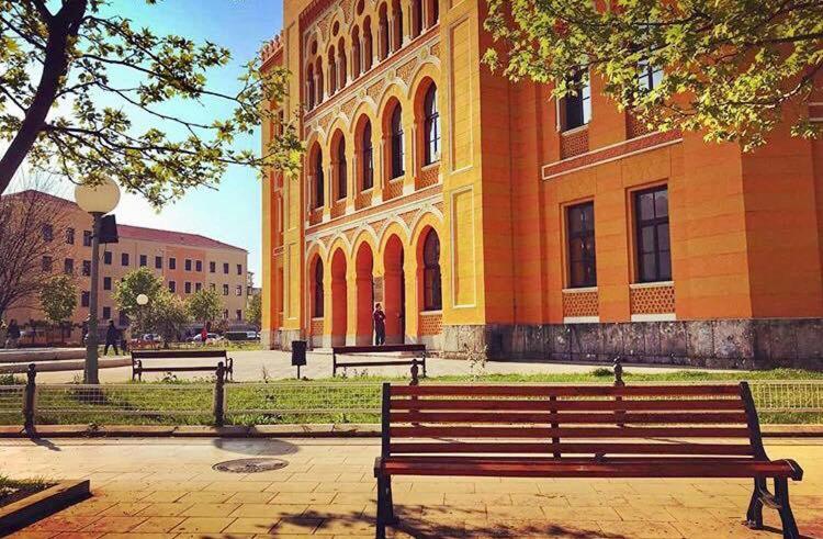 um banco de parque em frente a um edifício em Checkpoint apartments Mostar em Mostar