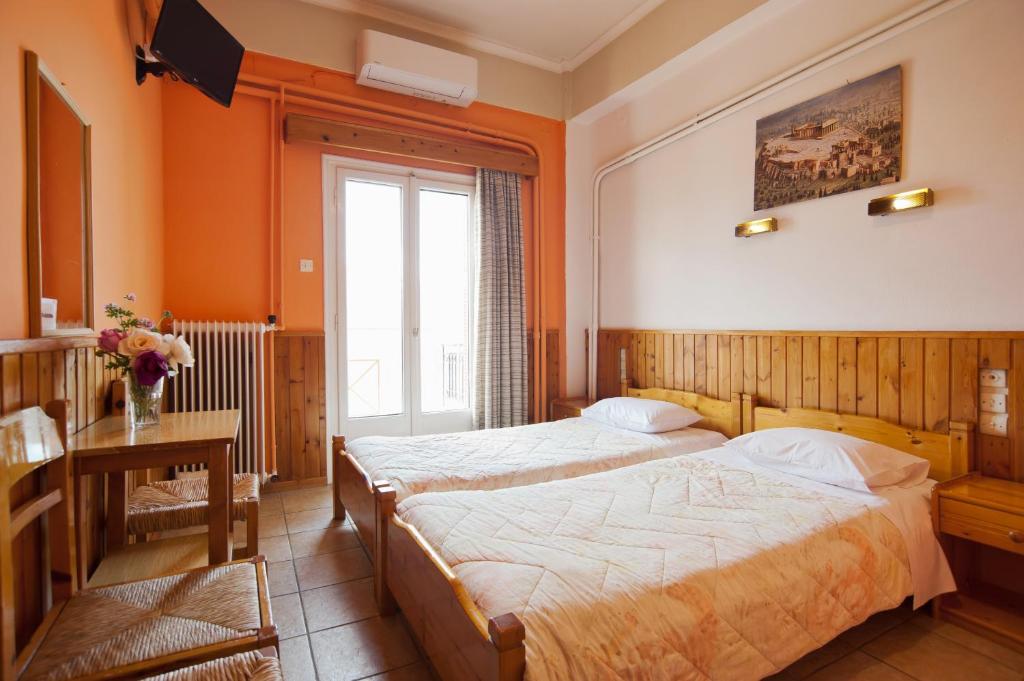 Postel nebo postele na pokoji v ubytování Hotel Athina