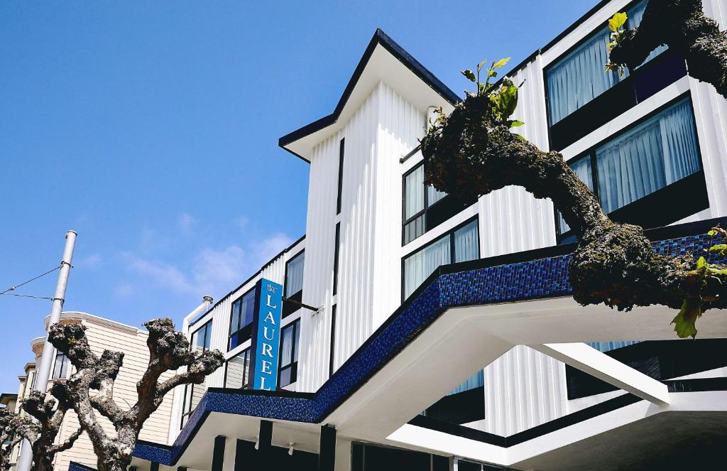 a white building with a blue and white staircase at The Laurel Inn, part of JdV by Hyatt in San Francisco