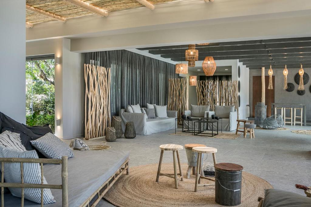 a living room with a couch and chairs and tables at Avithos Resort Hotel in Svoronata