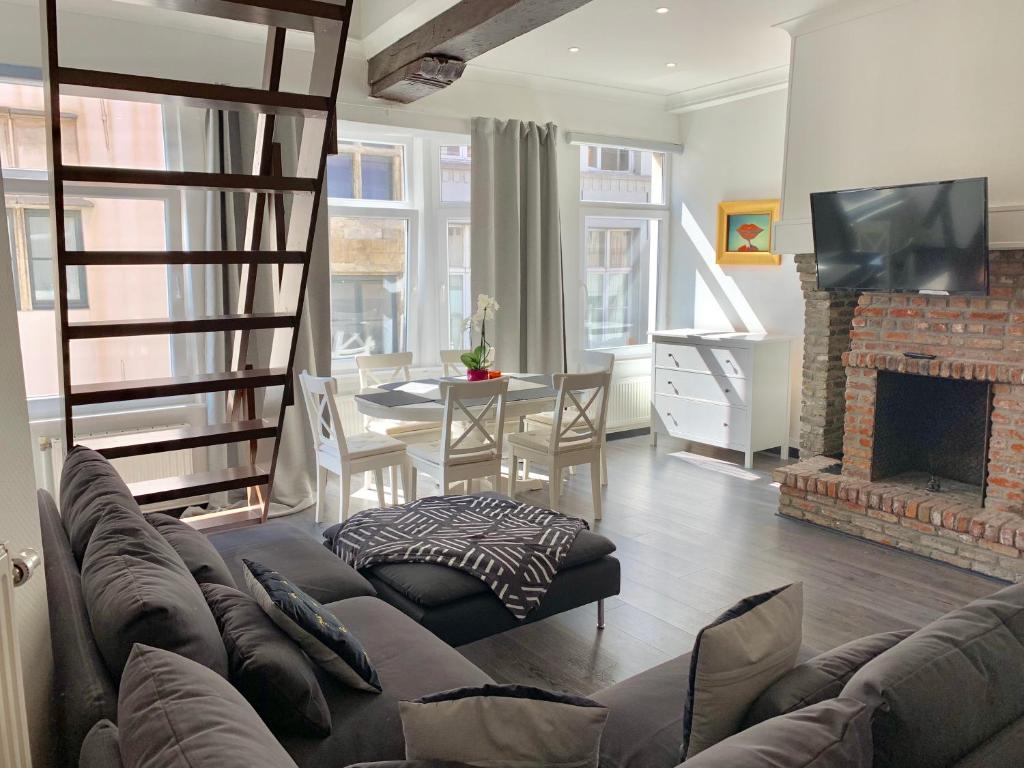 a living room with a couch and a fireplace at Luxury Suites Cathedral in Antwerp