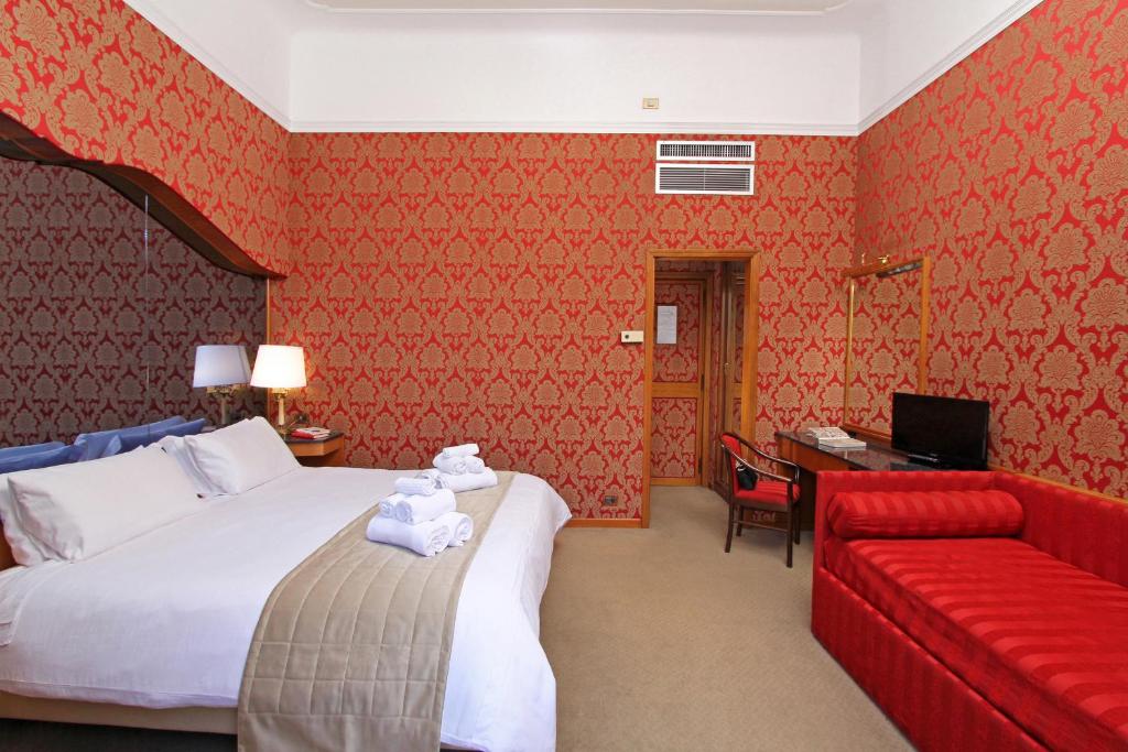Postel nebo postele na pokoji v ubytování Hotel Arcangelo