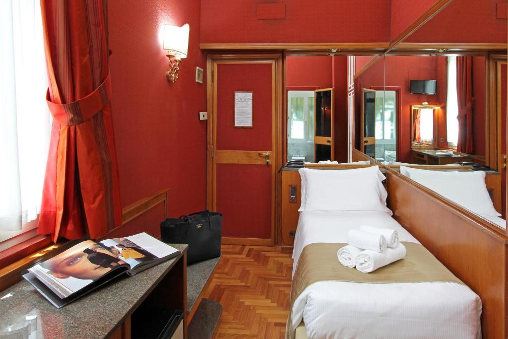 Postel nebo postele na pokoji v ubytování Hotel Arcangelo