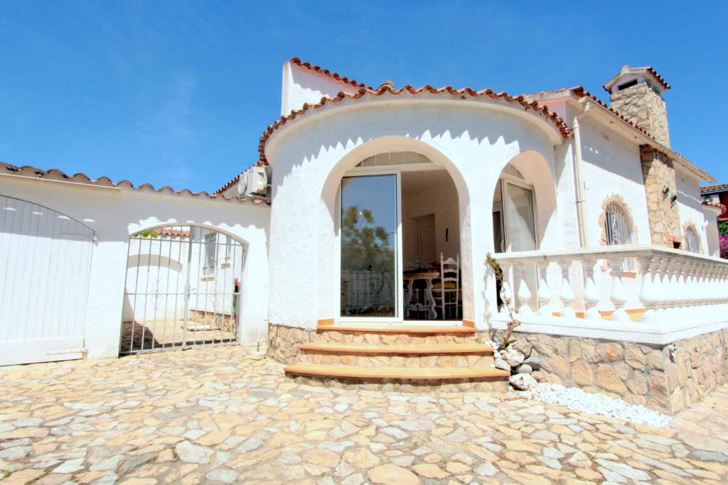 a large white house with a porch and stairs at LEON INMO Chalet Amira - 10191 in Empuriabrava