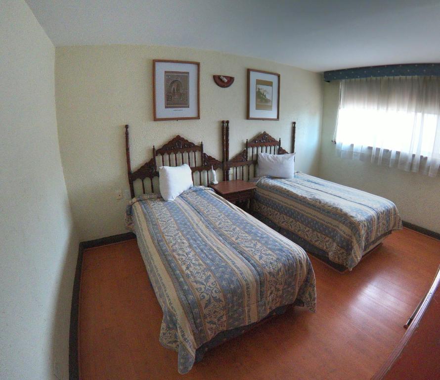 Postel nebo postele na pokoji v ubytování Hotel Posada Vista Bella