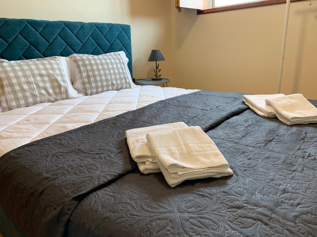 a bedroom with a bed with two towels on it at Invicta House Loft Boavista in Porto