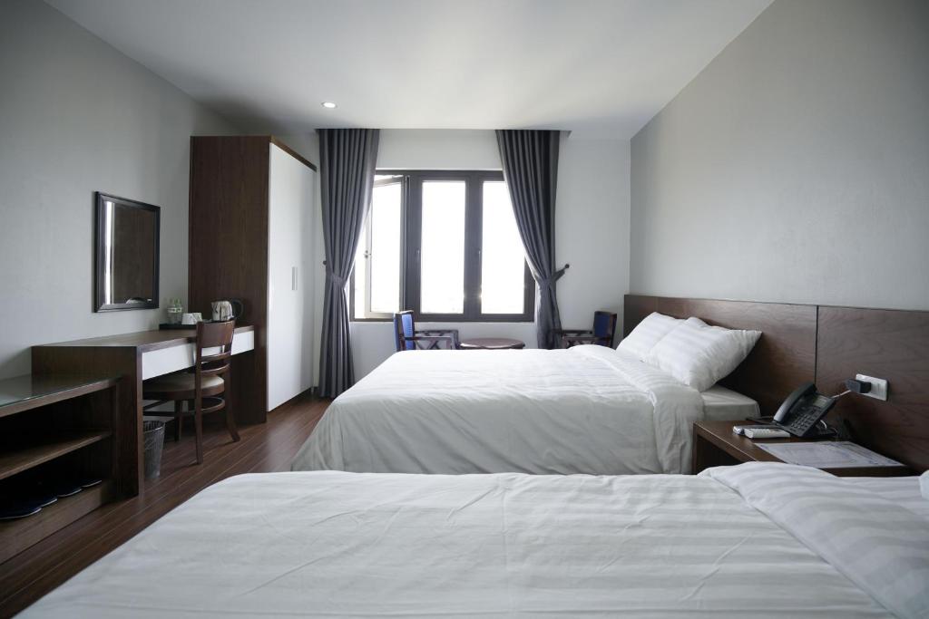 Ένα ή περισσότερα κρεβάτια σε δωμάτιο στο LEX HOTEL