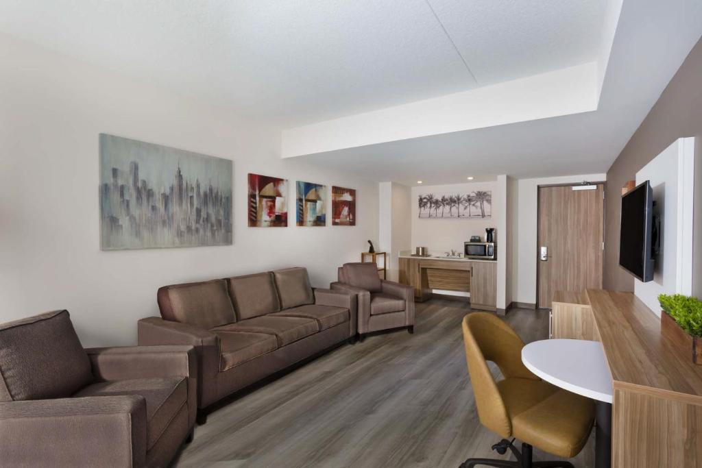 a living room with a couch and a table at Wyndham Garden Ft Lauderdale Airport & Cruise Port in Dania Beach