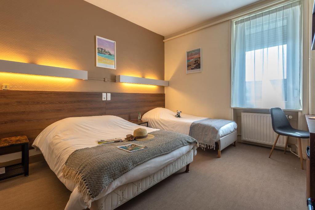 a hotel room with a bed and a desk at Anne De Bretagne in Vannes