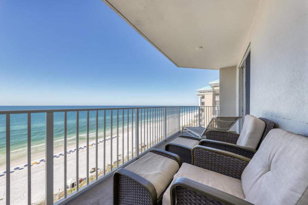 a balcony with chairs and a view of the beach at Majestic Sun 1111A Miramar Beach (Condo) in Destin
