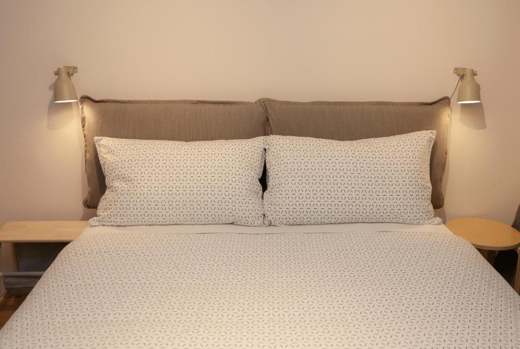 Postel nebo postele na pokoji v ubytování Apartments Alteri Domi