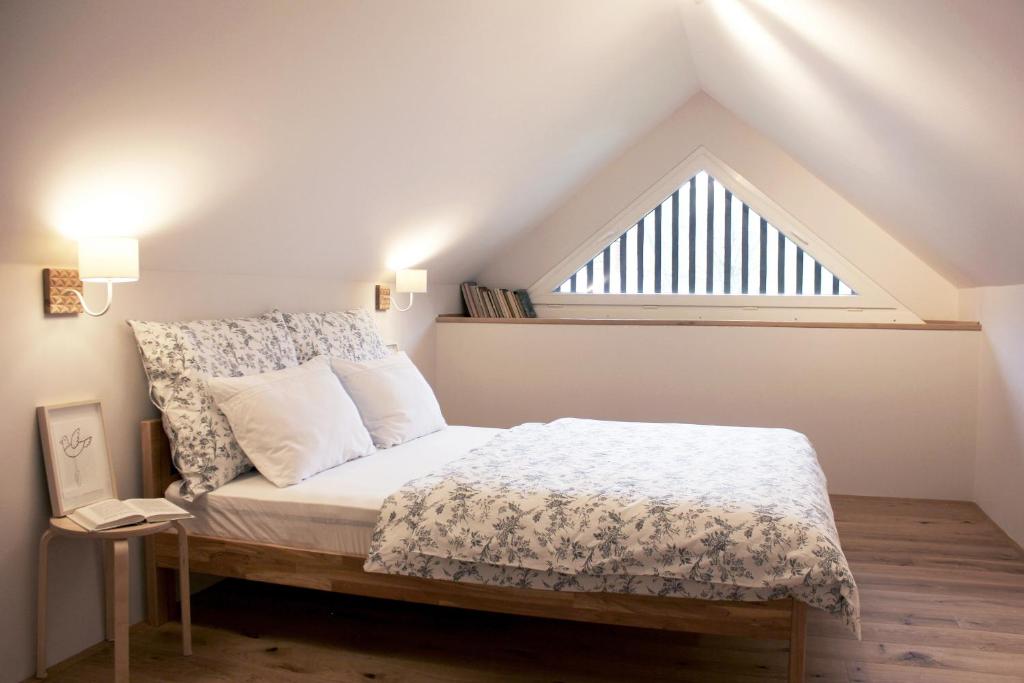 a bed in a room with a large window at Apartments Alteri Domi in Bohinj