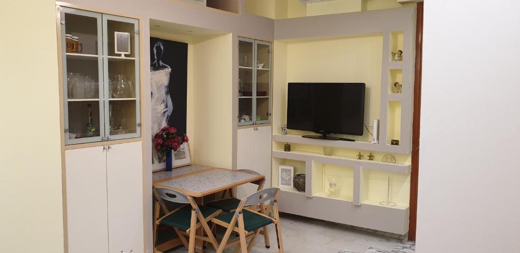 ラパッロにあるGrattacielo Apartmentのリビングルーム(テレビ、テーブル、椅子付)