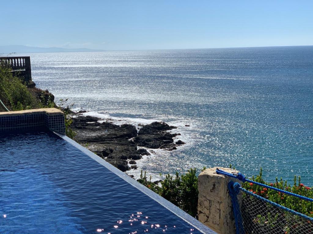 a swimming pool with a view of the ocean at Ocean View Echemare Tango Mar in Tambor
