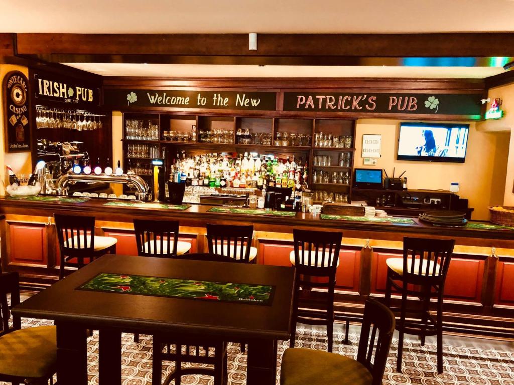 a bar in a restaurant with tables and chairs at Patrick's Pub in Maribor