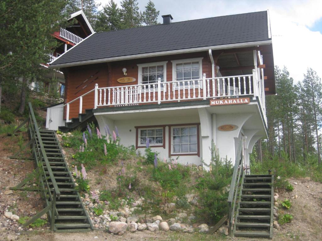 a house on a hill with stairs leading up to it at MukaLilla in Ukkohalla