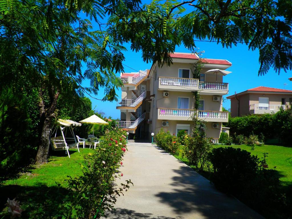 a building with a walkway in front of it at Alexia Apartments & Studios in Kremasti