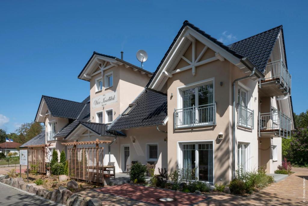 a large white house with a black roof at Villa Vier Inselblick in Freest