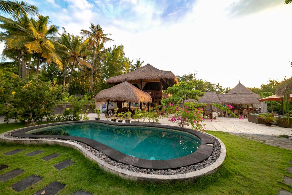 a swimming pool in front of a resort at Ceningan Resort in Nusa Lembongan