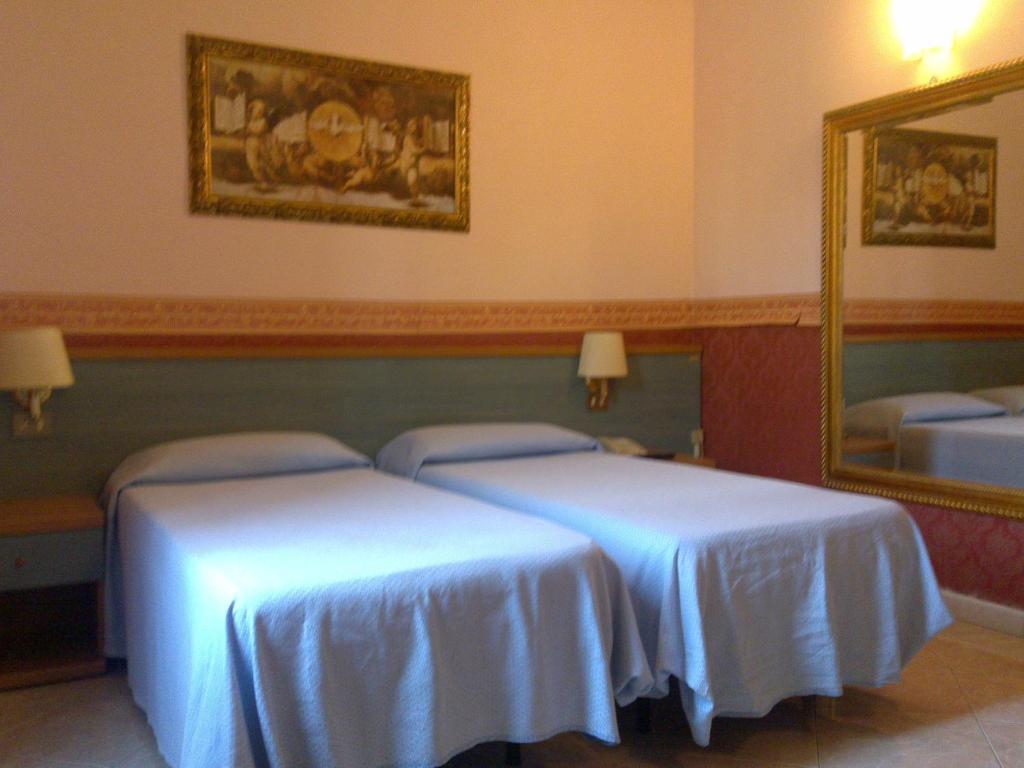 Postel nebo postele na pokoji v ubytování Hotel Lazzari