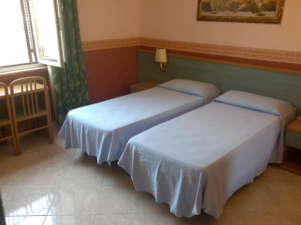 Postel nebo postele na pokoji v ubytování Hotel Lazzari