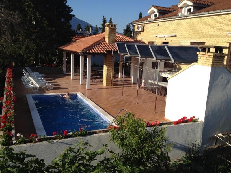 a swimming pool in the backyard of a house at Korcula Apartments Iliskovic in Korčula