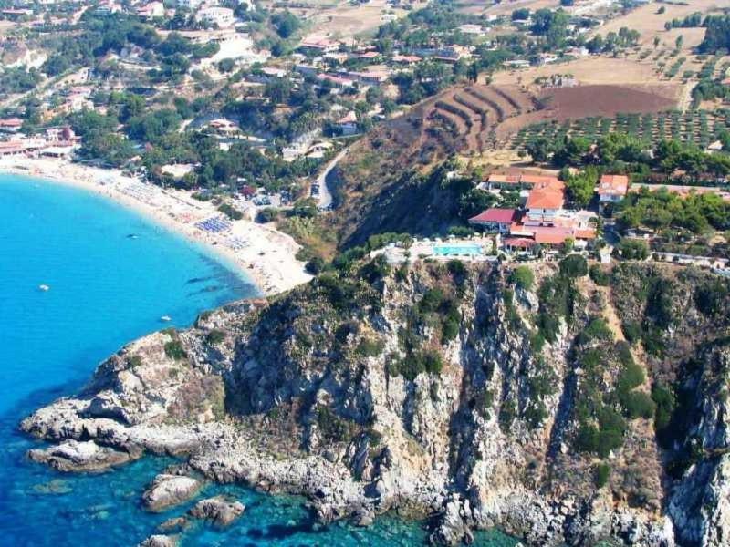 an aerial view of a village on a rocky coast at Villaggio Calispera in Capo Vaticano