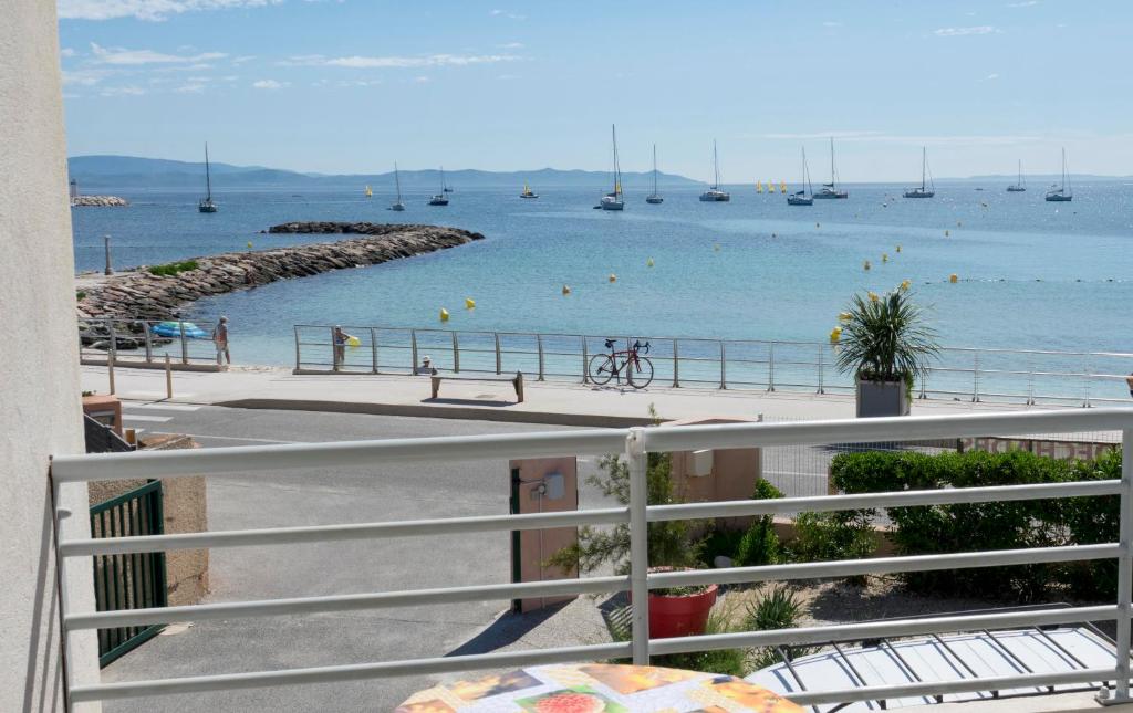 a view of a beach with boats in the water at Les Stoechades in Hyères