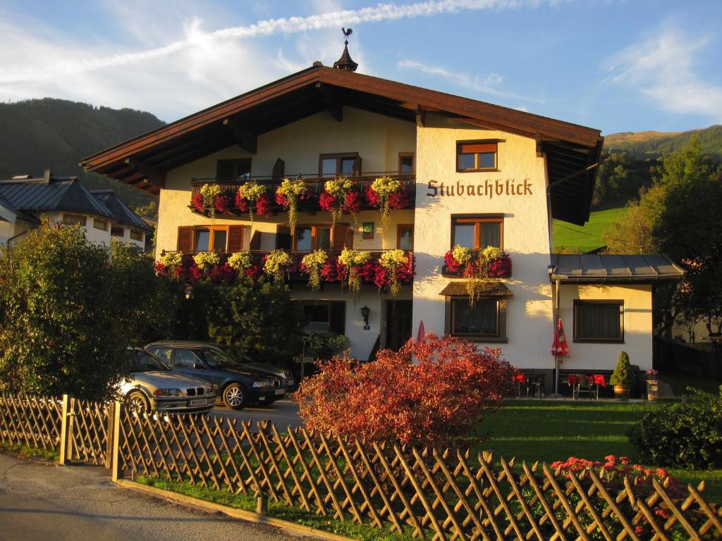 a building with flowers on the side of it at Pension Stubachblick in Uttendorf