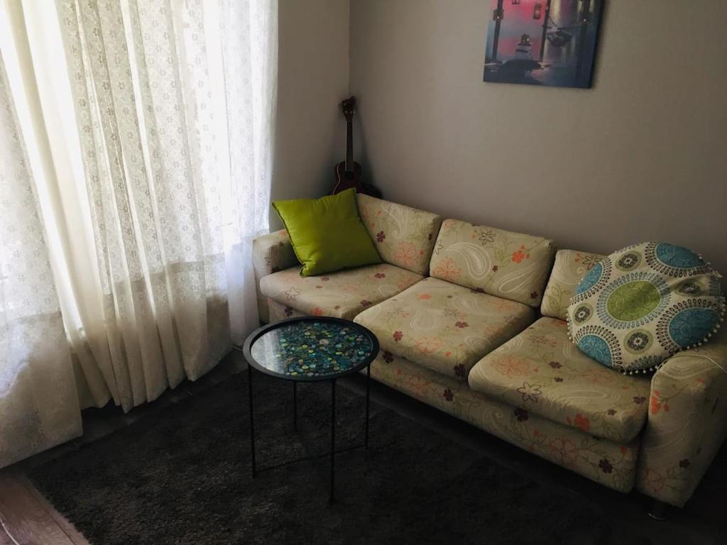 sala de estar con sofá y mesa en Apartment Button in downtown, en Sofía