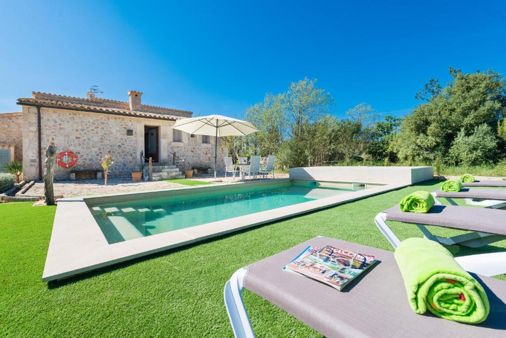 a villa with a swimming pool in a yard at Son Ferragut in Sa Pobla