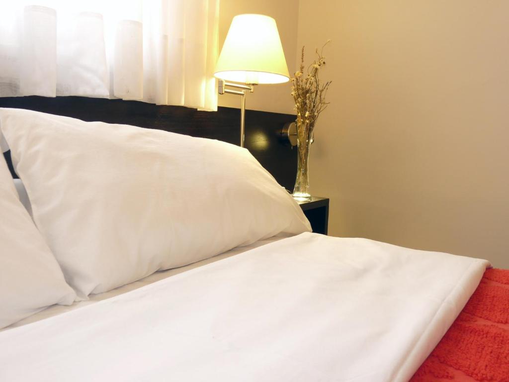 Postel nebo postele na pokoji v ubytování Hotel Arcos