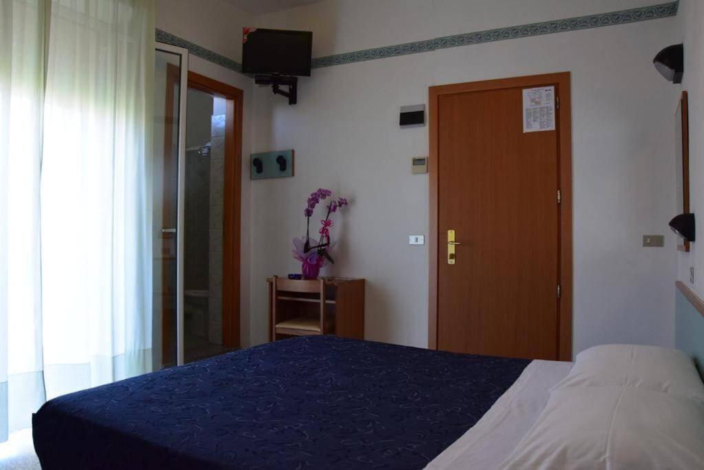 Postel nebo postele na pokoji v ubytování Hotel Luciana