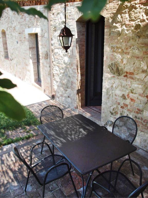 a black table and chairs on a patio at La Fornace di San Galgano in Chiusdino