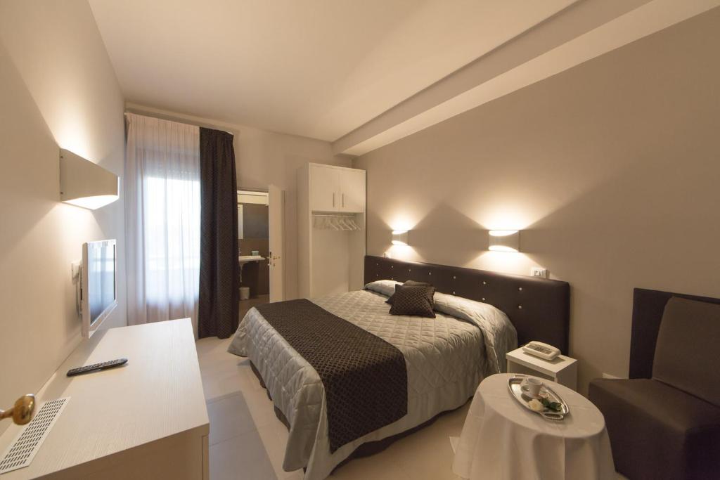 Ένα ή περισσότερα κρεβάτια σε δωμάτιο στο Hotel Delta