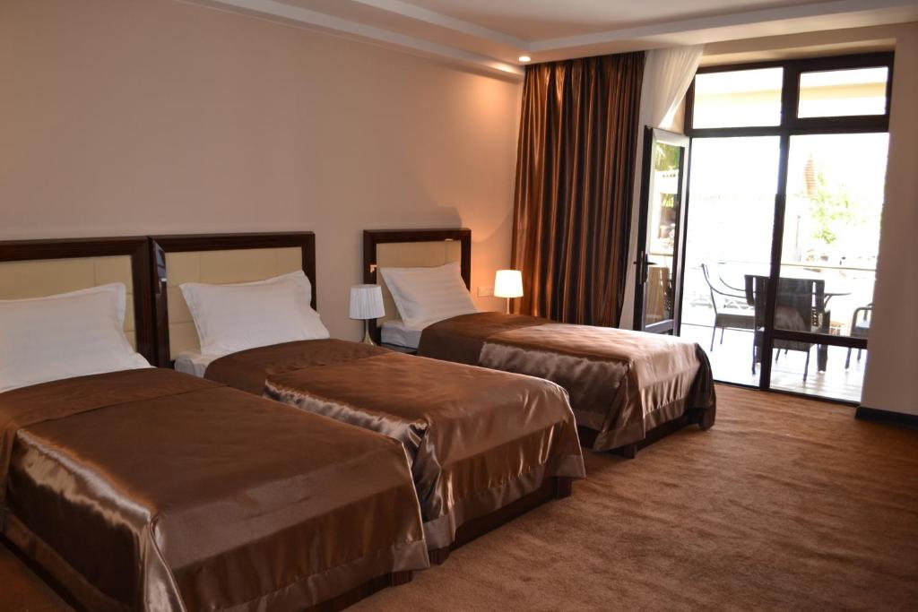 Postel nebo postele na pokoji v ubytování Pamir Palace