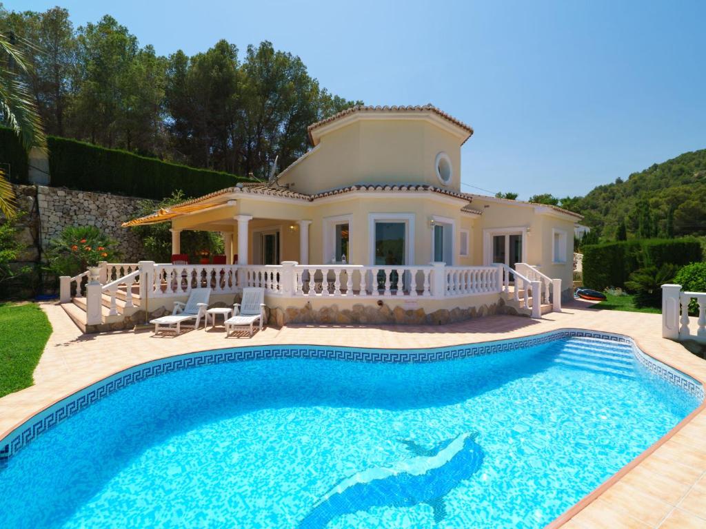 a villa with a swimming pool in front of a house at Holiday Home Montemar by Interhome in Fanadix