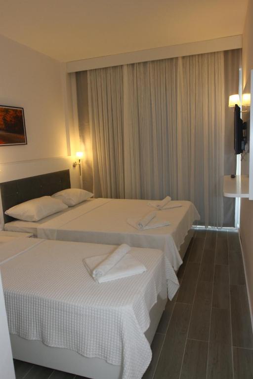 A bed or beds in a room at LİMAN BOUTIQUE OTEL